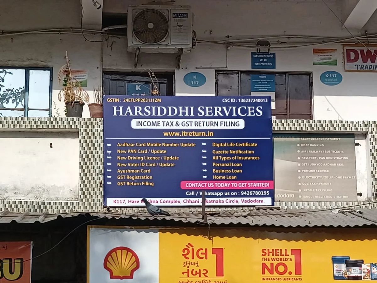The Harsiddhi Services board on the first floor of Hare Krishna Complex, seen from the road at Chhani Jakatnaka Circle, Vadodara.